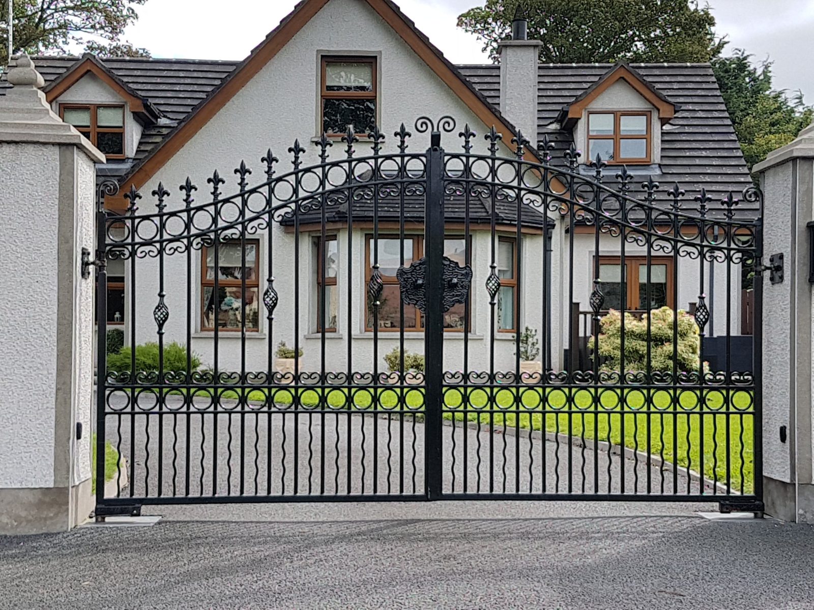 Ornate iron gates with underground motors like these for homes in Moira